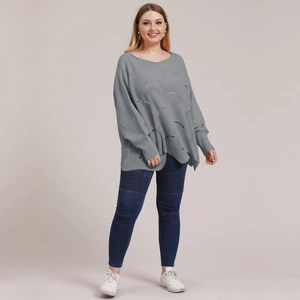 Detail of grey hollow-out wave texture knit sweater with loose batwing sleeves
