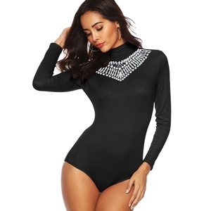 Close-up of black ribbed bodysuit featuring elegant white lace collar and mock neck details