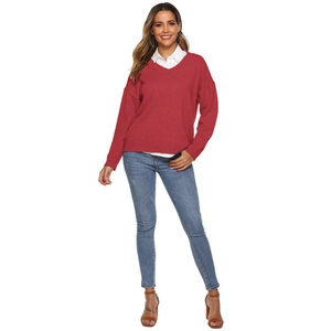 Detail of dark red V-neck knit sweater layered over a white shirt for a classic office look