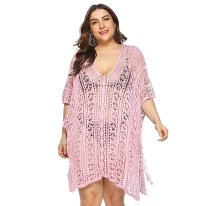 Close-up of pink crochet knit beach cover-up featuring deep V-neck and hollow texture