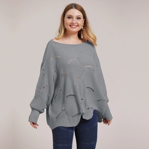 Detail view of grey oversized knit sweater with hollow wave patterns and batwing sleeves