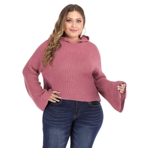 Detailed macro view of pink knit hoodie featuring stylish flared bell sleeves and texture