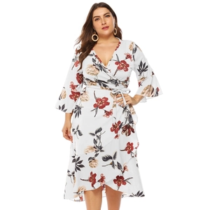 Detail of plus size floral wrap dress featuring ruffle hem and v-neckline