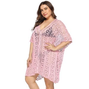Detail of light pink crochet hollow V-neck beach cover-up with intricate geometric textures