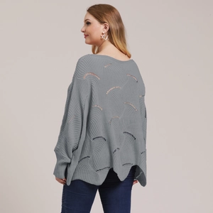 Detail of grey oversized sweater featuring unique hollow-out wavy patterns on the back