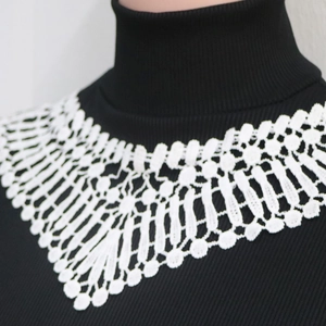 Detailed view of white floral lace collar overlay on a black long sleeve bodysuit
