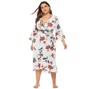 Detail of floral wrap dress with deep V-neck, ruffle sleeves and high waist tie closure