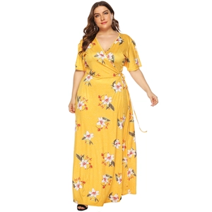 Detail of floral wrap dress with deep V-neck and waist tie in vibrant yellow