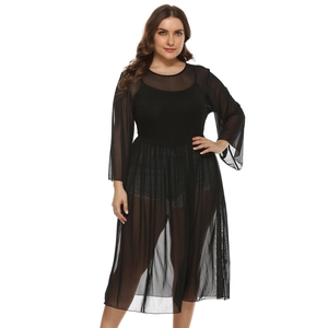 Detail of plus size black mesh sheer dress showing layering effect over casual outfit
