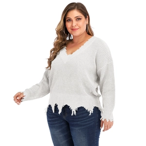 Detail showing distressed frayed edges and texture of white V-neck plus size knit sweater