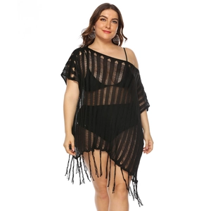 Close-up of black crochet beach cover-up with hollow-out texture and long fringe hem
