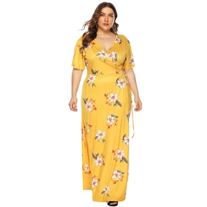 Close-up detail of yellow floral plus size maxi dress with deep V-neck and waist tie strap