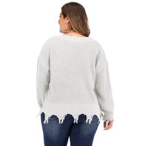 Detailed back view of white chunky knit sweater with distressed frayed hem details