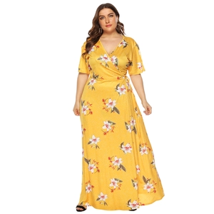 Close-up of yellow plus size wrap dress featuring floral prints and V-neck design