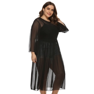 Detailed close-up of sheer mesh fabric and pleated waistline on black plus size dress