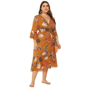 Detail of plus size floral wrap dress with ginger yellow fabric and ruffled sleeves