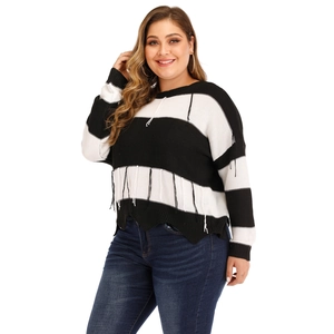 Women's plus size knit sweater with black and white stripes and tassel fringe details
