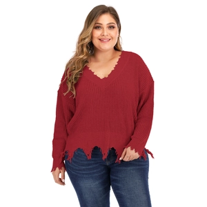 Detail showing distressed V-neckline and raw frayed edges of the dark red oversized sweater