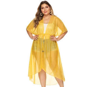 Detail of light yellow chiffon beach cover-up with drawstring waist and loose sleeves