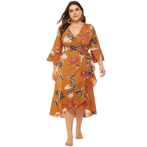 Plus size yellow floral wrap dress with V-neck, ruffle hem and flared bell sleeves