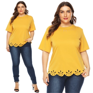 Detailed view of hollowed petal pattern on the hem of a bright yellow plus size T-shirt