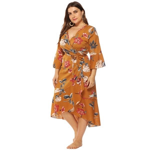Detail of plus size wrap dress with floral print, V-neck, and asymmetric ruffle hemline