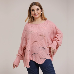Close-up of pink oversized batwing sleeve sweater with hollow-out knit texture