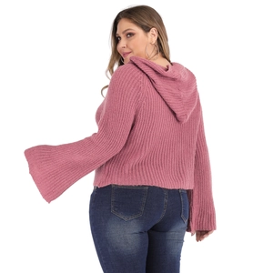 Close-up of pink knit hoodie with bell sleeves and ribbed texture from a back side view