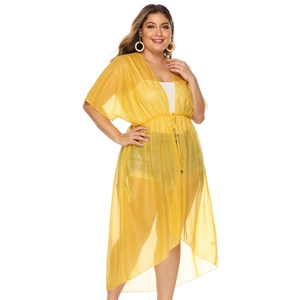 Detailed texture of yellow chiffon beach cover-up with drawstring waist and batwing sleeves