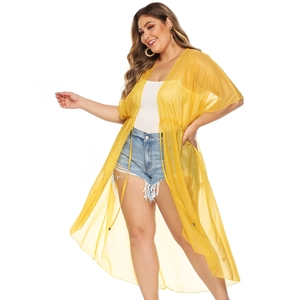 Detail of sheer yellow chiffon beach cover-up with adjustable waist drawstring and texture