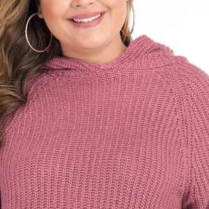 Detailed close-up of pink flared sleeve knit sweater with thick textured weave