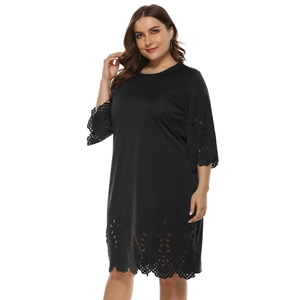 Detailed laser-cut floral pattern on cuffs and hem of a black plus size A-line dress