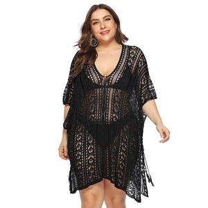 Detailed view of black crochet hollow-out V-neck beach cover-up with tassel fringe hem
