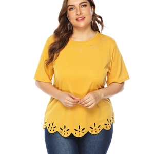 Detail of laser-cut petal patterns on yellow short-sleeved plus size t-shirt