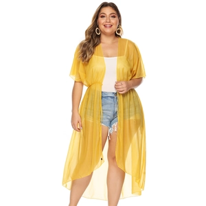 Detail of yellow chiffon cover-up showing waist drawstring and lightweight fabric