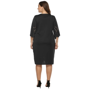 Detailed back view of a black A-line dress with laser-cut floral hollow out sleeves
