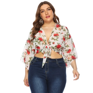 Detail of floral chiffon cardigan with bell sleeves and front tie knot closure