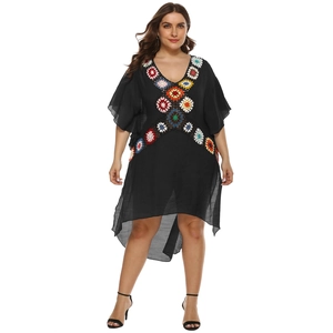 Plus size black beach cover-up with colorful crochet floral details and irregular hem