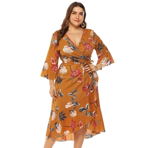 Detail of mustard yellow floral wrap dress with ruffle hem and bell sleeves