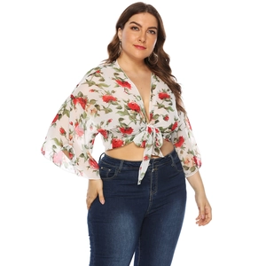 Detail of floral print chiffon cardigan with bell sleeves and front tie knot closure
