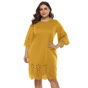Close-up of laser-cut hollow petal pattern on yellow plus size dress sleeve