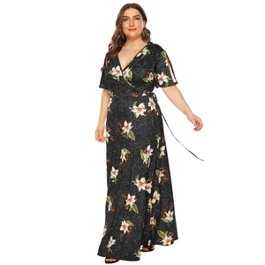 Detail of plus size floral maxi dress with deep V-neck, waist tie, and lily print pattern