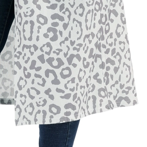 Detail of white longline leopard print cardigan showing high-quality hem stitching and knit fabric