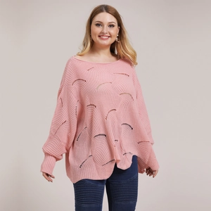 Detail of pink knitted sweater with hollow out wave texture and loose batwing sleeves