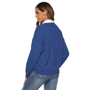 Detail of dark blue knit sweater with vertical texture and layered shirt style