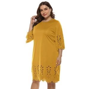 Plus size A-line dress in mustard yellow with laser-cut hollow details and 3/4 sleeves