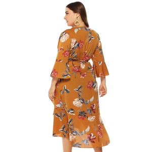 Plus size yellow floral dress with wrap design, ruffle hem and flared sleeves
