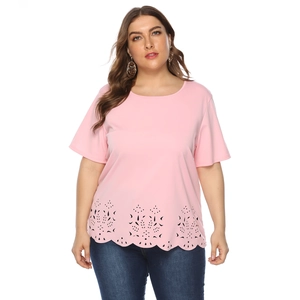 Detail of laser-cut eyelet floral pattern and wavy hem on pink short sleeve plus size top