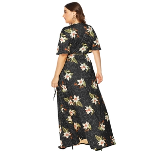 Detail of plus size floral maxi dress featuring white lilies and polka dot pattern