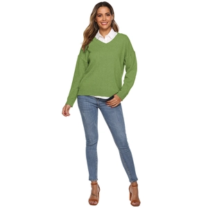 Women's V-neck green knit sweater in a loose fit styled with a white shirt